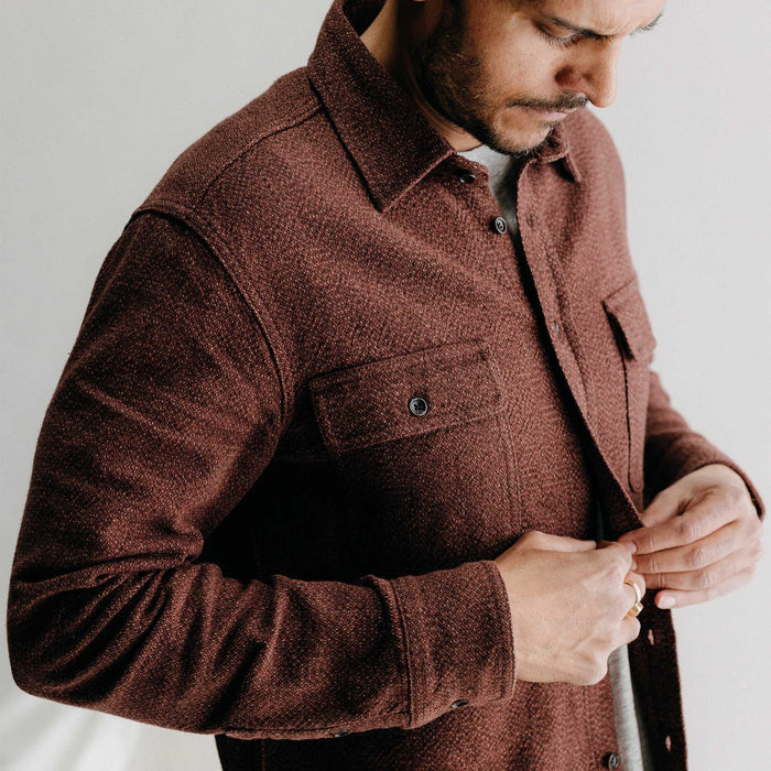 fit model buttoning up The Ledge Shirt in Burgundy Linen Tweed