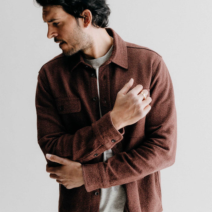 fit model adjusting the sleeves on The Ledge Shirt in Burgundy Linen Tweed