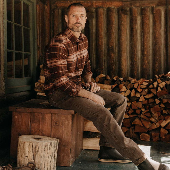fit model sitting wearing The Ledge Shirt in Chestnut Plaid