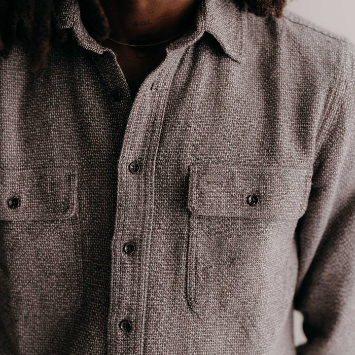 fit model buttoning up The Ledge Shirt in Granite Linen Tweed