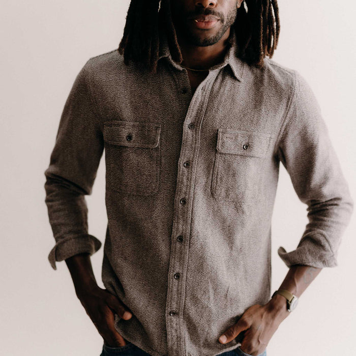 fit model leaning against the wall wearing The Ledge Shirt in Granite Linen Tweed
