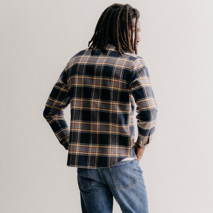 fit model showing off the back of The Ledge Shirt in River Plaid