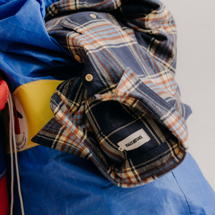 editorial image of The Ledge Shirt in River Plaid on a bag