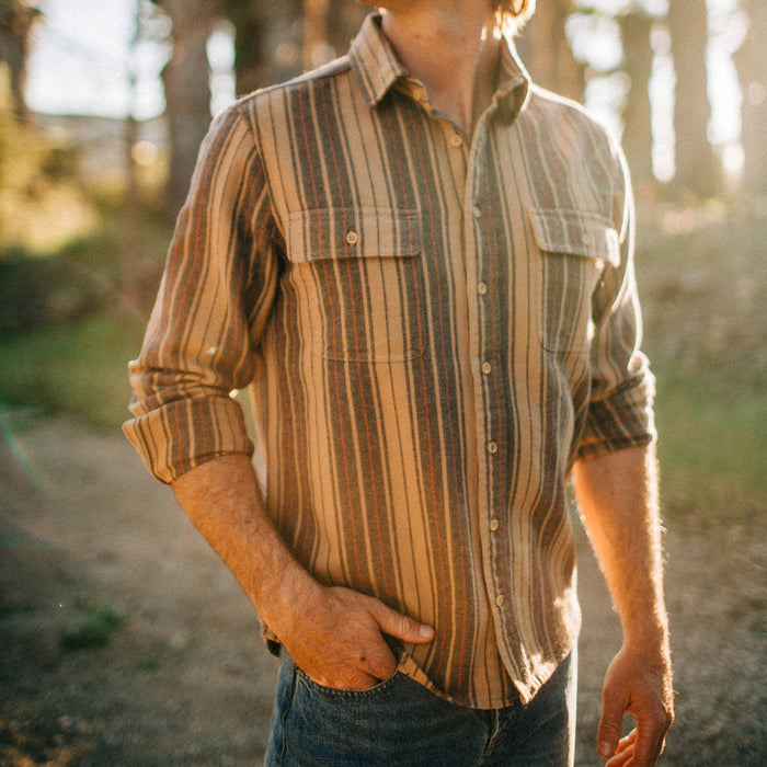 fit model standing in a field in The Ledge Shirt in Sunset Stripe