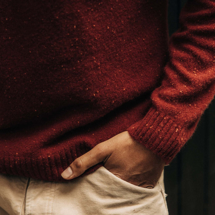 fit model with his hand in his pocket wearing The Lodge Sweater in Bonfire Donegal