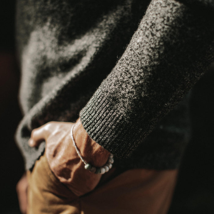 The fit model showing the cuff detail of the lodge sweater