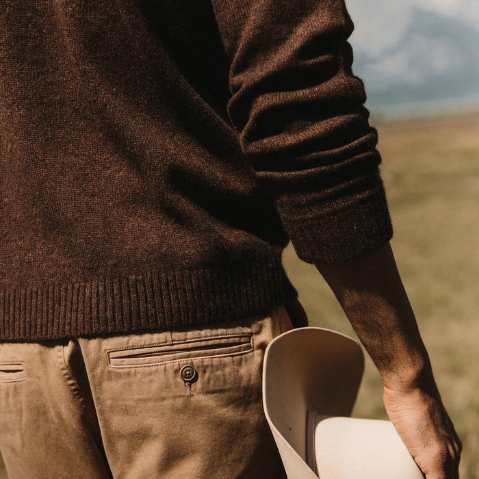 fit model wearing the lodge sweater, back shot holding hat