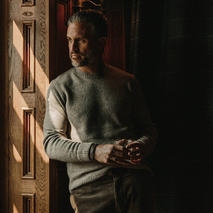 fit model wearing the lodge sweater, looking left