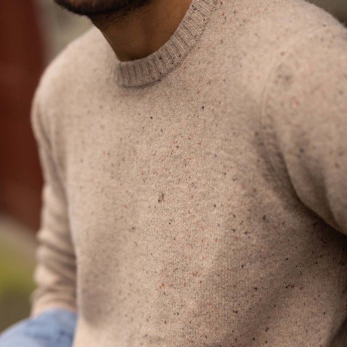fit model showing off sweater details on The Lodge Sweater in Sand Donegal