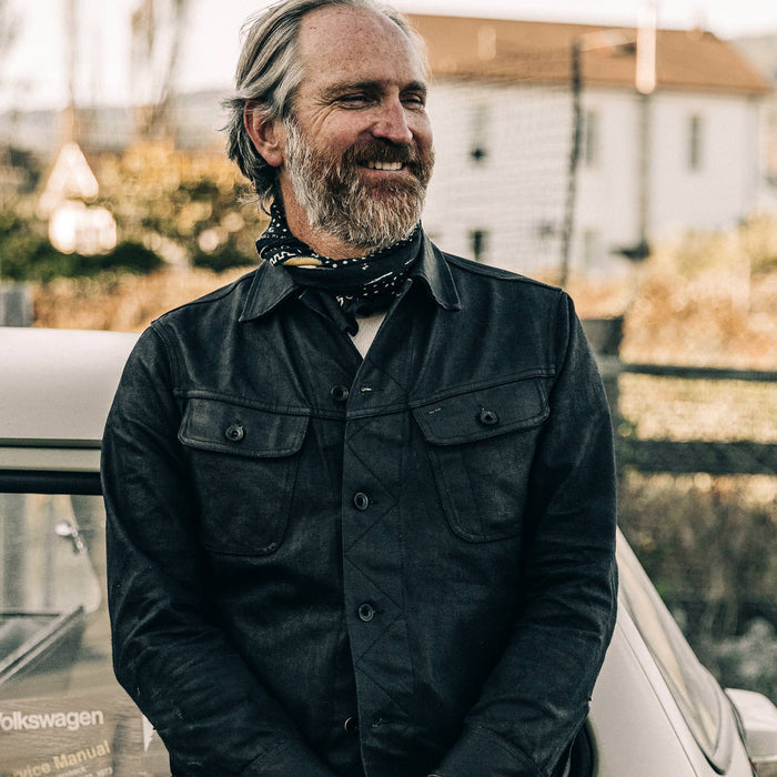 fit model wearing The Long Haul Jacket in Black Over-dye Selvage, smiling