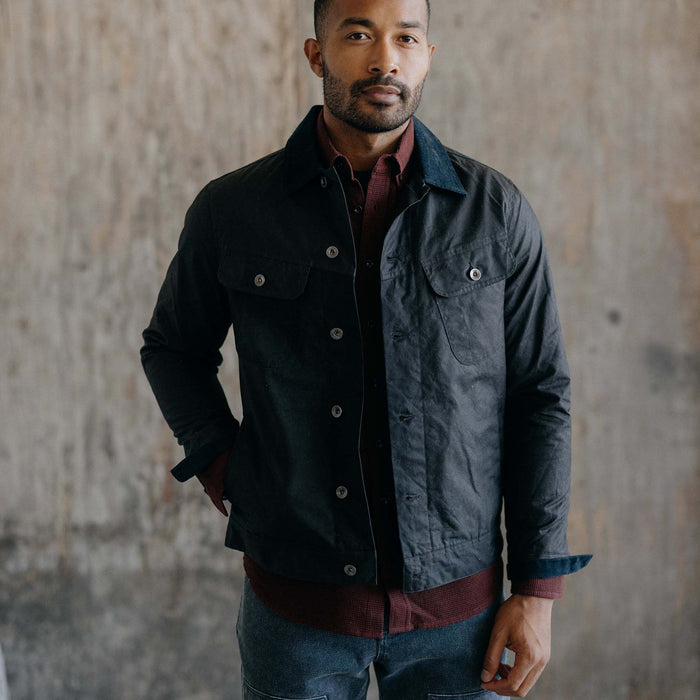 fit model posing in The Long Haul Waxed Canvas Jacket in Coal