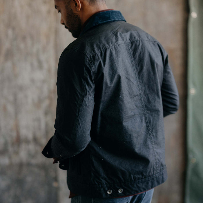 fit model showing off the back of The Long Haul Jacket in Coal Waxed Canvas