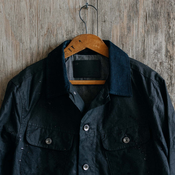 editorial image of The Long Haul Jacket in Coal Waxed Canvas hanging