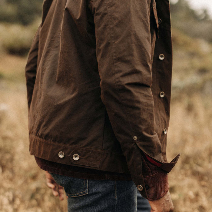 fit model showing off hem and cuff on The Long Haul Jacket in Dark Khaki Waxed Canvas