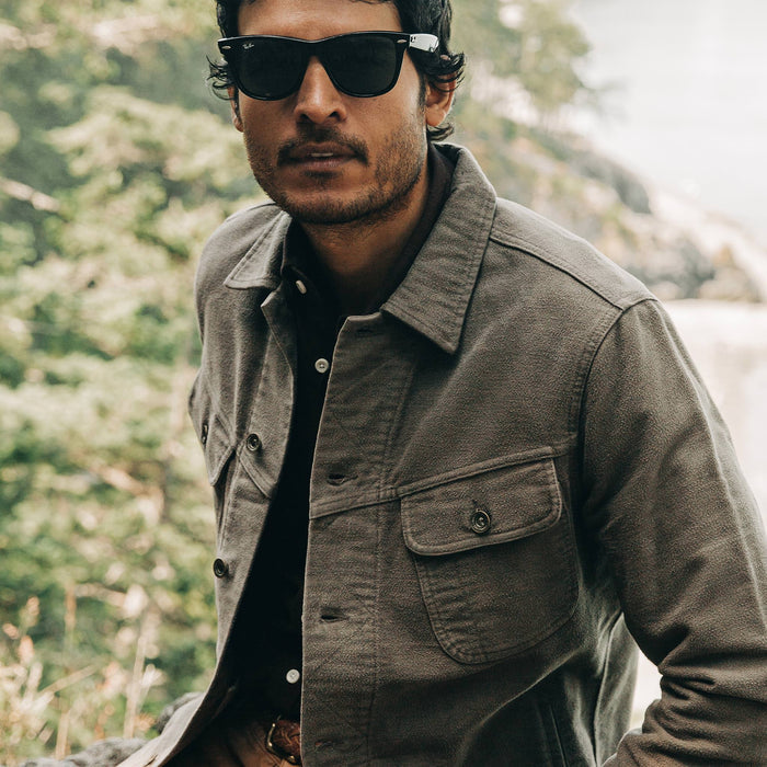 our fit model wearing The Long Haul Jacket in Moss Brushed Reverse Sateen—looking at camera with sunglasses on