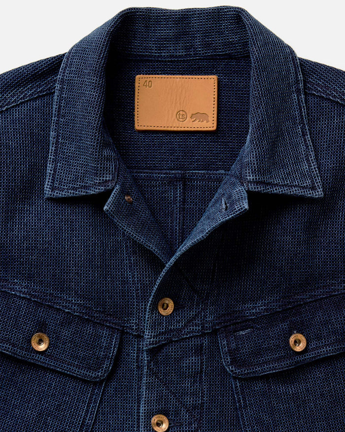 fit model showing the collar detail on The Long Haul Jacket in Rinsed Indigo Waffle