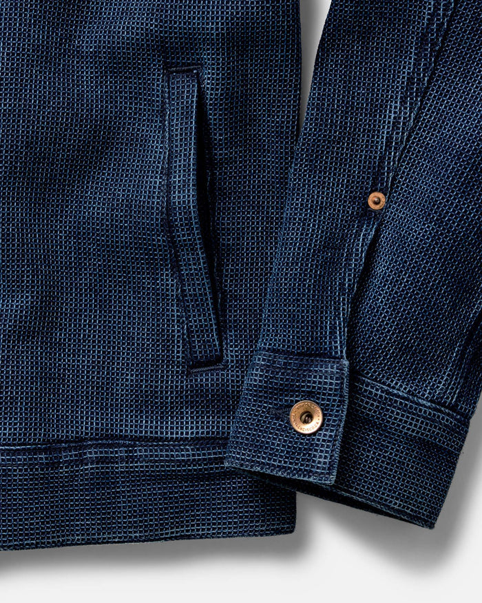 The Long Haul Jacket in Rinsed Indigo Waffle hanging on the wall