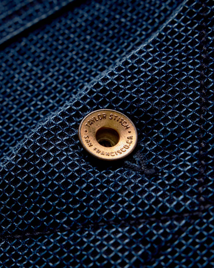 Close up of the leather label on The Long Haul Jacket in Rinsed Indigo Waffle