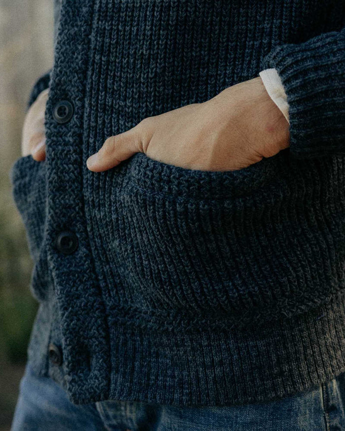 fit model with his hands in the pockets of The Mariner Shawl Cardigan in Ink Slub