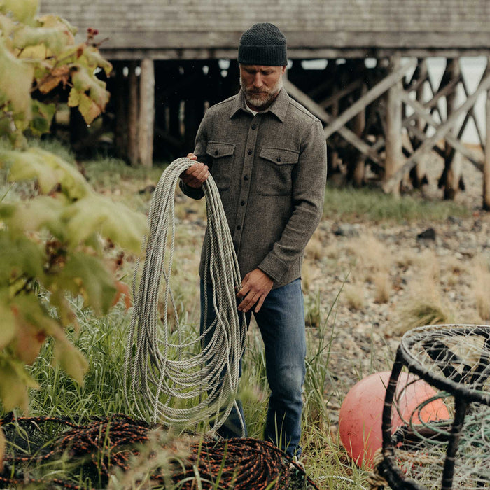 fit model holding rope wearing The Maritime Shirt Jacket in Ash Twill