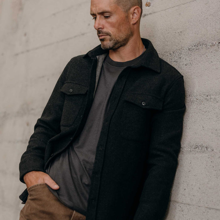 fit model leaning against the wall wearing The Maritime Shirt Jacket in Heather Charcoal