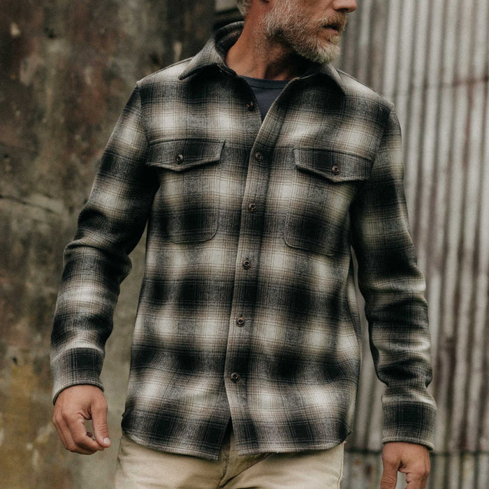 fit model posing on The Maritime Shirt Jacket in Olive Plaid