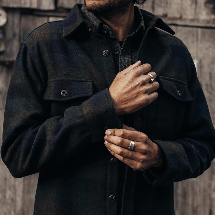 fit model adjusting the cuff on The Maritime Shirt Jacket in Pike Plaid