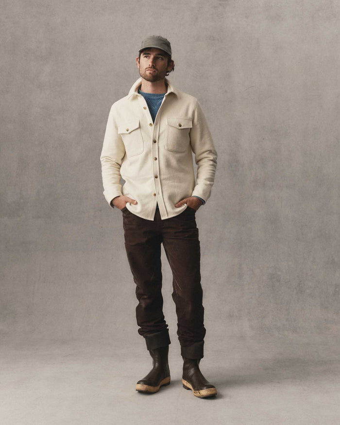 fit model with his hands in his pockets wearing The Maritime Shirt Jacket in Vintage White Moleskin Twill
