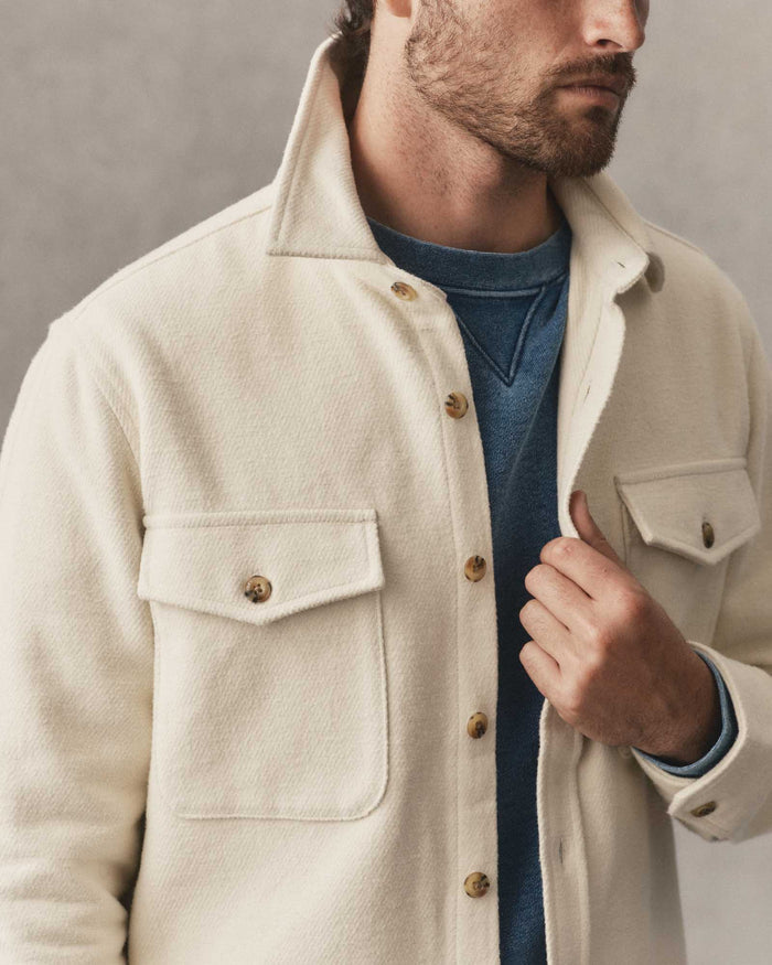 fit model holding The Maritime Shirt Jacket in Vintage White Moleskin Twill