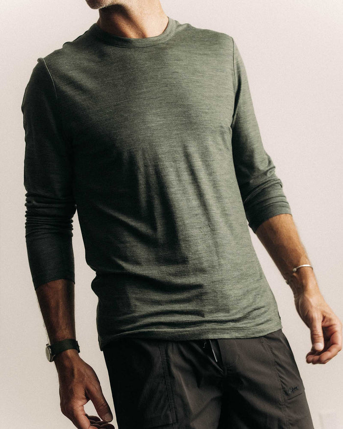 fit model posing in The Merino Long Sleeve Tee in Heather Army