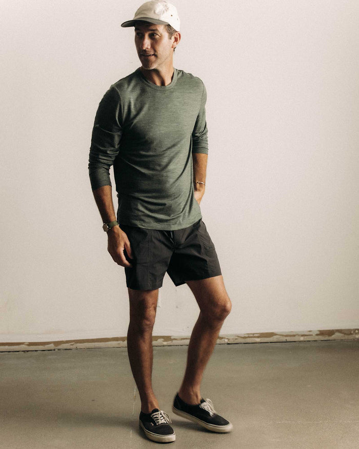 fit model showing off The Merino Long Sleeve Tee in Heather Army