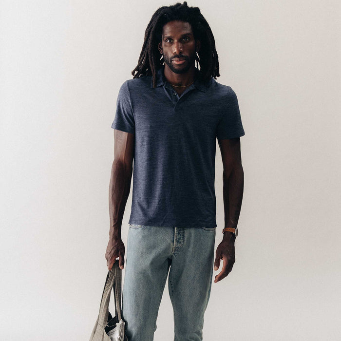 fit model standing wearing The Merino Polo in Heather Navy