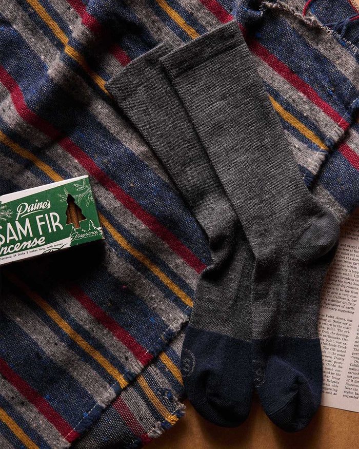 material shot of The Merino Sock in Charcoal next to incense