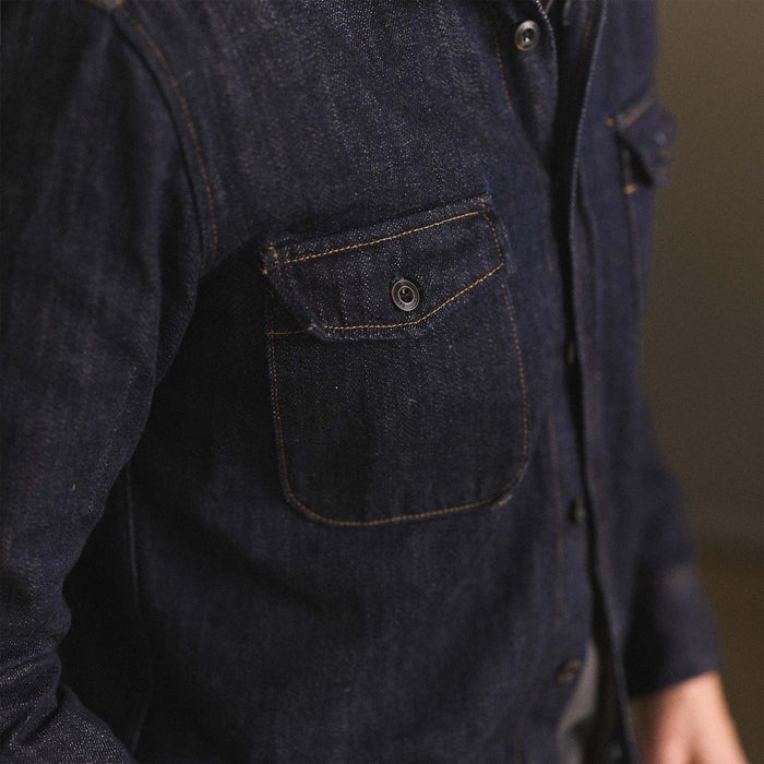 fit model showing off the pockets on The Mill Shirt Jacket in Kuroki Slub Denim