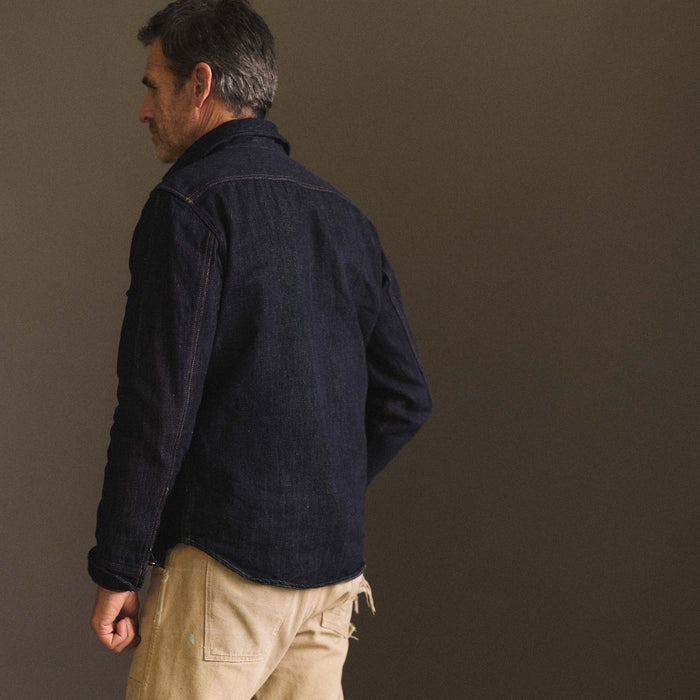 fit model showing the back of The Mill Shirt Jacket in Kuroki Slub Denim