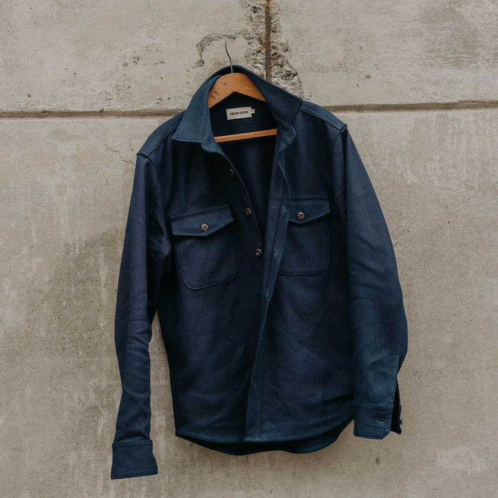 editorial image of The Mill Shirt Jacket in Rigid Indigo Sashiko hanging