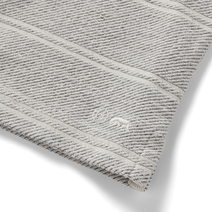 material shot of the logo on The Morgan Crewneck in Ash Stripe