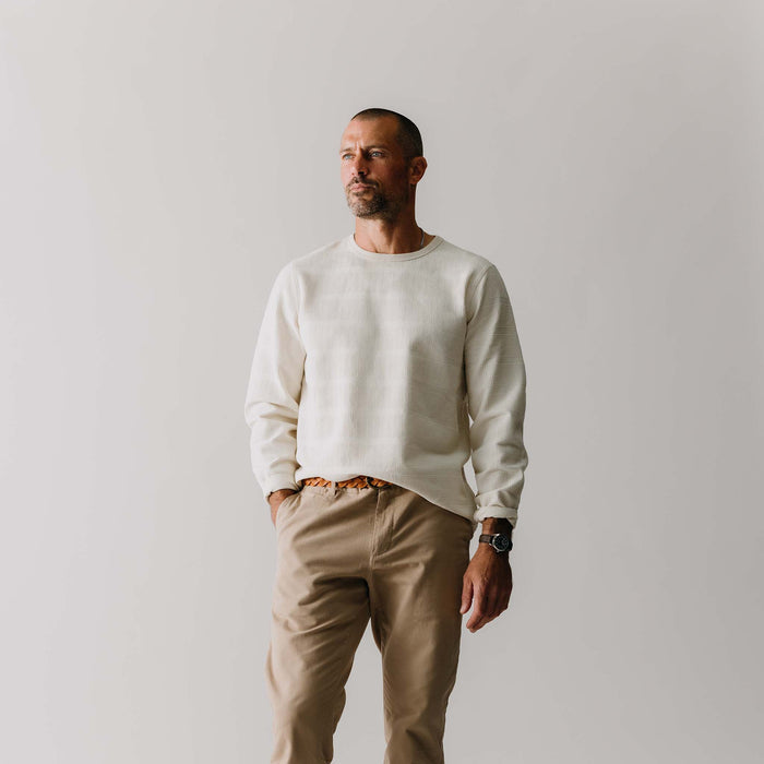 fit model with his hand in his pocket wearing The Morgan Crewneck in Natural Slub Stripe