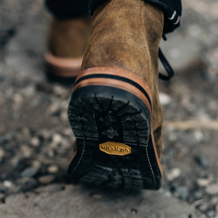 material shot of the soles on The Moto Boot in Golden Brown Waxed Suede