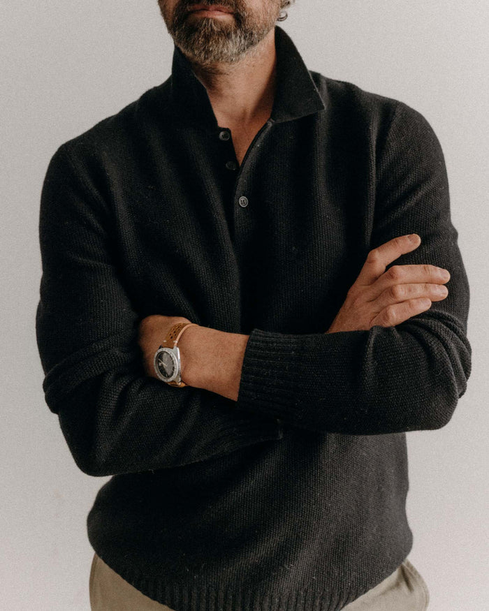 fit model posing in The Newton Sweater Polo in Midnight Merino