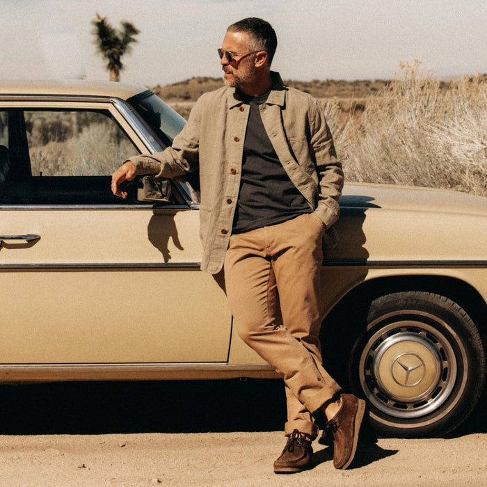 fit model leaning against a vintage mercedes in The Ojai Jacket in Arid Eucalyptus Hemp
