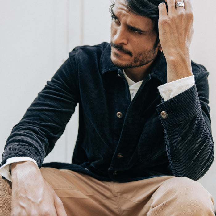 fit model sitting wearing The Ojai Jacket in Coal Cord