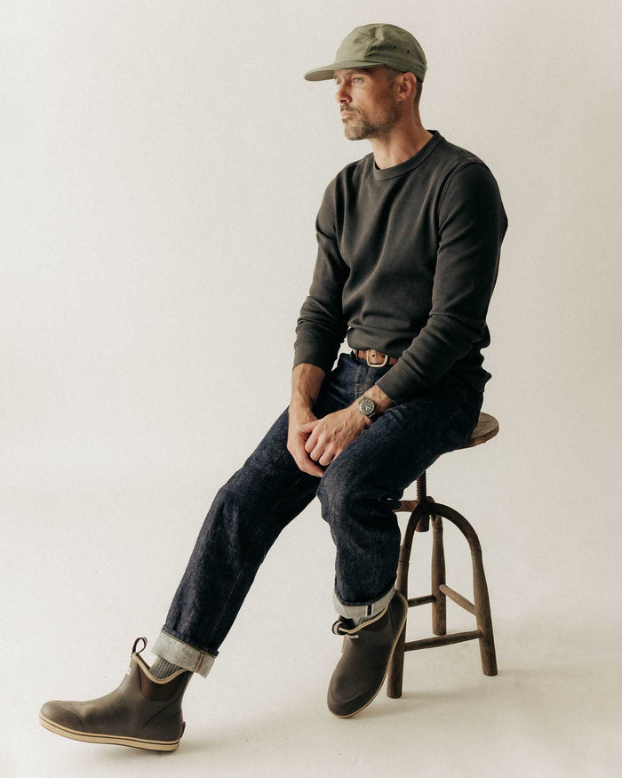 fit model sitting wearing The Organic Cotton Crew in Faded Black Waffle