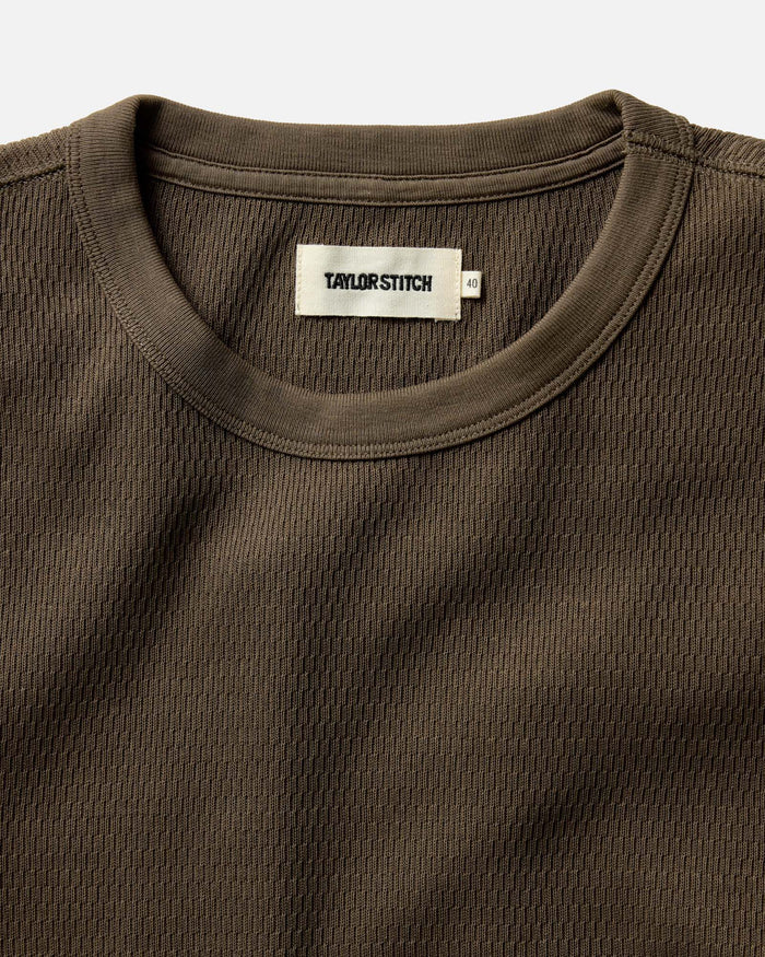 fit model walking on a beach in The Organic Cotton Waffle Crew in Fatigue Olive