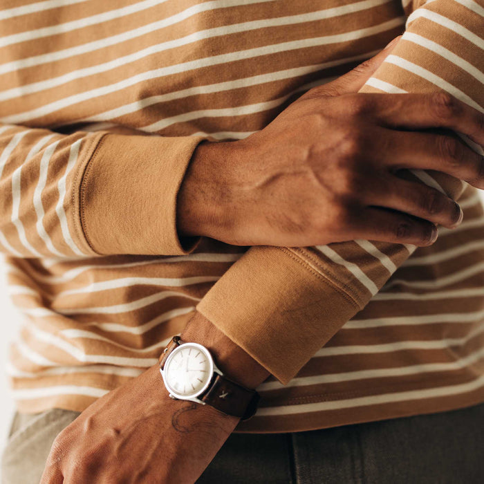 fit model showing off the cuffs on The Organic Cotton Long Sleeve Tee in Churro Stripe