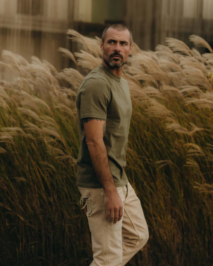 fit model showing off the sleeves on The Organic Cotton Shop Tee in Army Twist