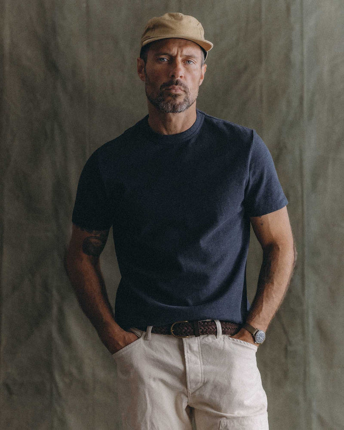 fit model sitting wearing The Organic Cotton Shop Tee in Navy Twist