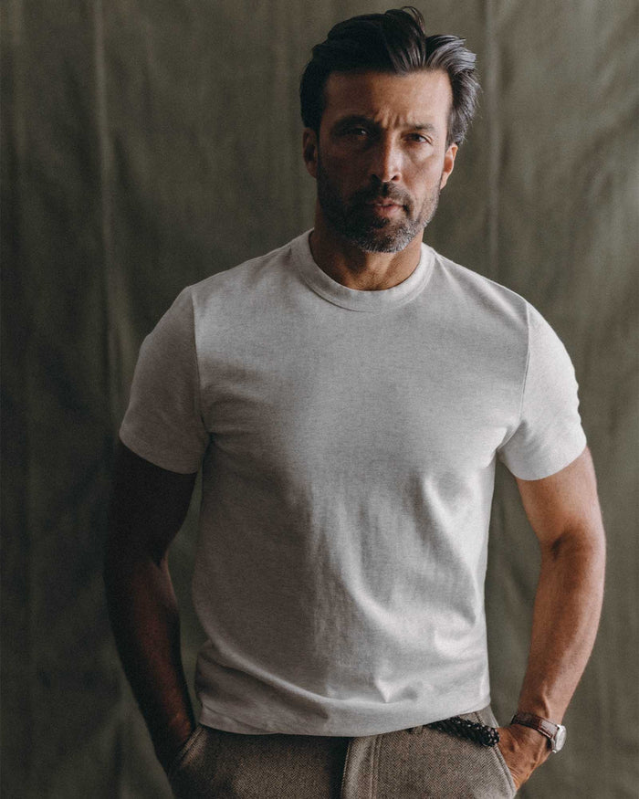 fit model leaning against the wall wearing The Organic Cotton Shop Tee in Oat Twist