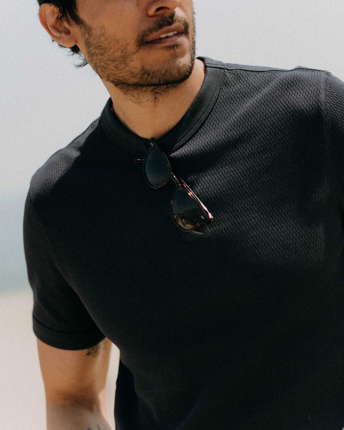 fit model with his arms crossed wearing The Organic Cotton Short Sleeve Crew in Dark Navy Waffle
