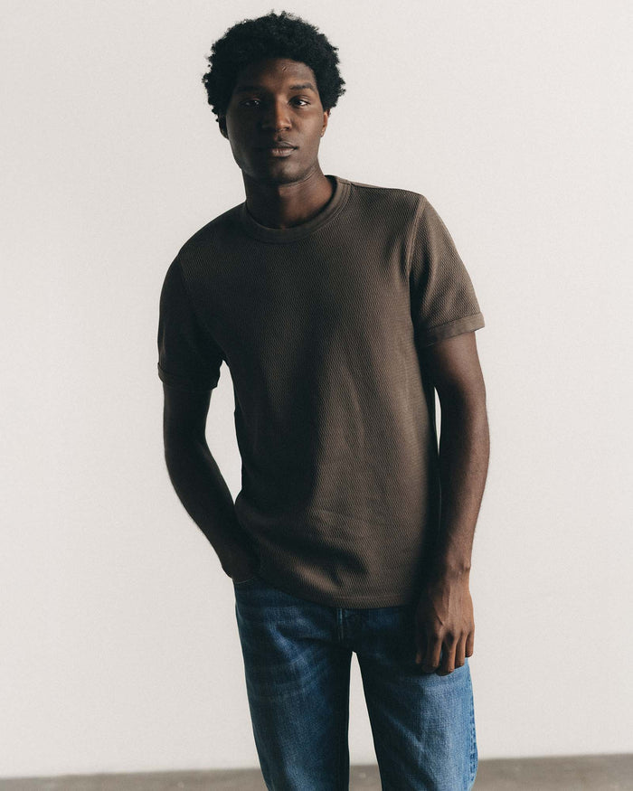 fit model sitting in The Organic Cotton Short Sleeve Crew in Fatigue Olive Waffle